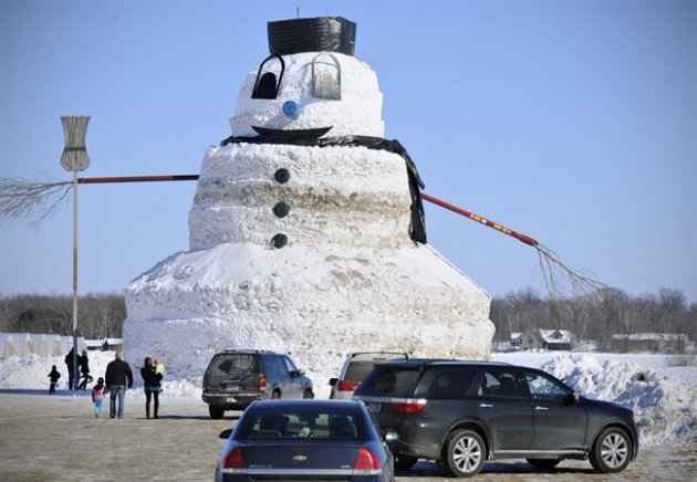 This Sunday, March 2, 2014 photo shows a giant 50-foot snowman created by Greg Novak in Gilman, Minn. Novak says he's invested hundreds of hours to build a 50-foot snowman named "Granddaddy" that he hopes will wake onlookers from their winter doldrums. And he admits it has some neighbors questioning his sanity. Granddaddy began to take shape earlier this winter when the Gilman farmer needed to move mounting snow piles away from his greenhouses. (AP Photo/ St. Cloud, Jason Wachter)