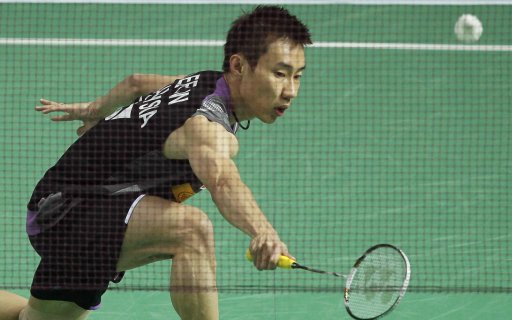 Lee of Malaysia hits a return against Tago of Japan in their men's singles match at the China Open badminton tournament in Shanghai