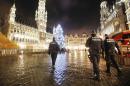 Belgian police officers patrol the Grand Place in downtown Brussels, Belgium, Monday, Nov. 23, 2015. The Belgian capital Brussels has entered its third day of lockdown, with schools and underground transport shut and more than 1,000 security personnel deployed across the country. (AP Photo/Michael Probst)