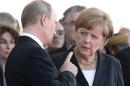 Russian President Vladimir Putin talks with German Chancellor Angela Merkel as they attend the International 70th D-Day Commemoration Ceremony in Ouistreham