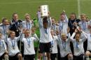 Germany's captain Celia Sasic, center, lifts up the trophy to celebrate with teammate after winning the women's soccer Algarve Cup at the Algarve stadium, outside Faro, southern Portugal, Wednesday, March 12, 2014. (AP Photo/Francisco Seco)
