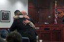 In this July 16, 2013 photo, Levi Chavez, 32, left, hugs his defense attorney, David Serna, in Sandoval District Court in Bernalillo, N.M., after a jury acquitted him of murdering his wife, 26-year-old Tera Chavez, in 2007 and making it look like a suicide. The jury's decision came after more than 10 hours of deliberations and a month long trial detailing Chavez's many affairs, charges of a botched investigation and allegations of a police cover-up. (AP Photo/Russell Contreras)
