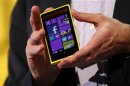 Microsoft CEO Steve Ballmer displays a Nokia Lumia 920 featuring Windows Phone 8 during an event in San Francisco