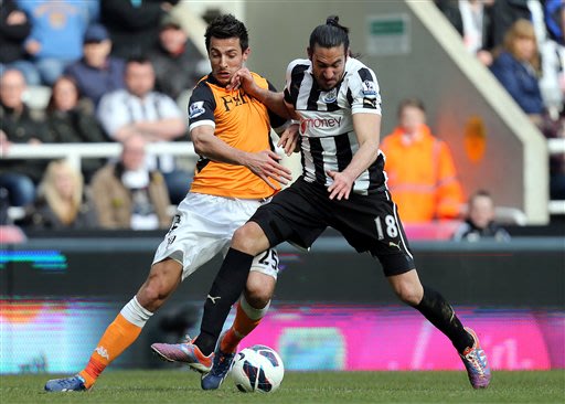 Newcastle United's Jonas Gutierrez, right, vies for the ball with Fulham's Stanislav Manolev, left, during their English Premier League soccer match at St James' Park, Newcastle, England, Sunday, April 7, 2013