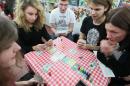 High school students play a new board game that ridicules the communist-era food and goods rationing system as the game is launched in Warsaw, Poland, Monday, Nov. 17, 2014. "Regulation. The Coupons Game" was launched Monday by the state-run National Remembrance Institute, which teaches about Polish history. In the game, players are tasked with duties like cooking a dinner or doing the washing and need to cleverly trade their rationing coupons to be able to buy the necessary products before they run out. (AP Photo/Czarek Sokolowski)