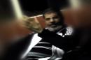 This image made from undated video posted on the website of the el-Watan newspaper on Sunday, Nov. 3, 2013, shows ousted President Mohammed Morsi during his detention at an undisclosed facility in Egypt following his ouster. A newspaper known for close ties to the military published what appeared to be the first pictures of Morsi from his detention. A military official said the video was leaked to the paper in order to give his supporters a first glance of the former president to lessen the impact of the shock of his first public appearance at a trial that started Monday under heavy security.(AP Photo/el-Watan Newspaper via AP video)
