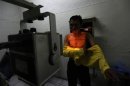 A patient suspected of having tuberculosis puts on his shirt after an x-ray at the Indonesian Union Against Tuberculosis clinic in Jakarta