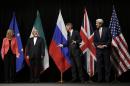 British Foreign Secretary Philip Hammond, 2nd right, U.S. Secretary of State John Kerry, right, and European Union High Representative for Foreign Affairs and Security Policy Federica Mogherini, left, talk to Iranian Foreign Minister Mohammad Javad Zarif as the wait for Russian Foreign Minister Sergey Lavrov, not pictured, for a group picture at the Vienna International Center in Vienna, Austria, Tuesday, July 14, 2015. After 18 days of intense and often fractious negotiation, world powers and Iran struck a landmark deal Tuesday to curb Iran's nuclear program in exchange for billions of dollars in relief from international sanctions — an agreement designed to avert the threat of a nuclear-armed Iran and another U.S. military intervention in the Muslim world. (Carlos Barria, Pool Photo via AP)