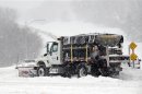 A snowplow clears a road during a blizzard in Kansas City, Kansas