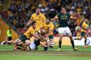 Michael Hooper of the Australian Wallabies, left, tackles South African Springboks player Faf de Klerk, center bottom, during the Rugby Championship match between the Wallabies and the Springboks at Suncorp Stadium in Brisbane, Saturday, Sept. 10, 2016. (Dave Hunt/AAP Image via AP)