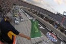 The green flag is waved to start the NASCAR Sprint Cup Series auto race on Saturday, Aug. 25, 2012, in Bristol, Tenn. (AP Photo/Jason Smith, CIA Bristol Motor Speedway, Pool)