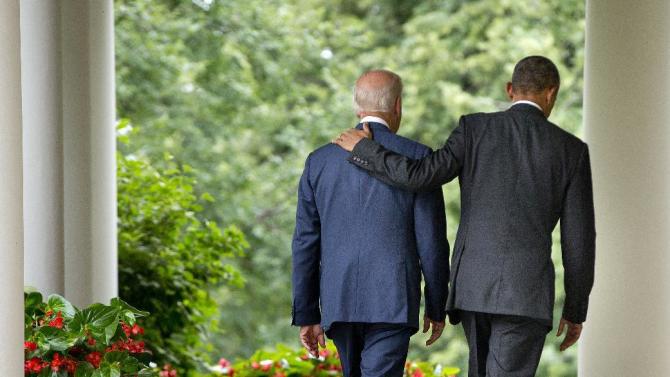 President Barack Obama walks with Vice President Joe Biden back to the Oval Office of the White House in Washington, Thursday, June 25, 2015, after speaking in the Rose Garden after the Supreme Court upheld the subsidies for customers in states that do not operate their own exchanges under President Barack Obama&#39;s Affordable Care Act. (AP Photo/Pablo Martinez Monsivais)