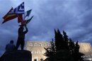 Protestor raises flags of Portugal, Italy, Greece and Spain in front of the parliament in Syntagma square during a 48-hour strike by the two major Greek workers unions in central Athens