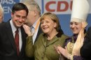 German Chancellor Merkel and Lower Saxony's Christian Democratic state governor McAllister (CDU) laugh after an election campaign in Stade