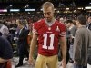 San Francisco 49ers quarterback Alex Smith walks on the field after he was not given a booth to answers question from journalists during Media Day for the NFL's Super Bowl XLVII in New Orleans