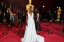 Lupita Nyong'o, best supporting actress nominee for her role in "12 Years a Slave" and wearing a Prada gown, arrives at the 86th Academy Awards in Hollywood