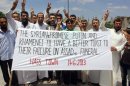 In this citizen journalism image provided by Edlib News Network, ENN, which has been authenticated based on its contents and other AP reporting, anti-Syrian regime protesters hold a banner and flash the victory sign during a demonstration in Hass town, Idlib province, northern Syria, Friday, June 14, 2013. The Syrian government on Friday dismissed U.S. charges that it used chemical weapons as "full of lies," accusing President Barack Obama of resorting to fabrications to justify his decision to arm Syrian rebels. The commander of the main rebel umbrella group welcomed the U.S. move. (AP Photo/Edlib News Network ENN)