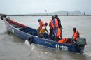 Rescue workers leave the coast to find the victims of a capsized pirogue on September 1, 2012 in Conakry