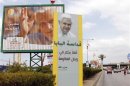 Billboards and a banner erected by Hezbollah depicting Pope Benedict XVI are seen installed at the main airport road in Beirut