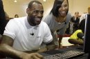 FILE - In a March 2, 2011 file photo, Miami Heat basketball player LeBron James, center, sits with his girlfriend Savannah Brinson, right, at a new computer during a charity event at the Northwest Boys & Girls Club in Miami. James married Savannah Brinson at the posh Grand Del Mar Hotel in San Diego on Saturday, Sept. 15, 2013, according to two people familiar with the details of the ceremony. About 200 guests were present for the ceremony, said one of the people, both of whom spoke on condition of anonymity because the wedding was private and the couple had yet to release any details. James and Brinson, 27, have been together since high school and have two sons. (AP Photo/Lynne Sladky, File)