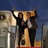 President Barack Obama and first lady Michelle Obama wave as they board Air Force One at Andrews Air Force Base, Md., Friday, Dec. 21, 2012 before departing for Hawaii. (AP Photo/Ann Heisenfelt)