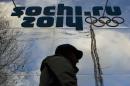 A man walks past a shop with an Olympic logo in the Black Sea resort town of Sochi