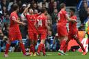 Liverpool's Philippe Coutinho, second left, celebrates scoring during their English Premier League soccer match against Queens Park Rangers at Loftus Road, London, Sunday, Oct. 19, 2014. (AP Photo/Tim Ireland)