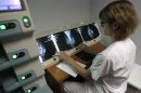 A radiologist examines breast X-rays after a cancer prevention medical check-up at the Ambroise Pare hospital in Marseille