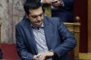 Greece's Prime Minister Alexis Tsipras looks at his watch during a parliament meeting in Athens, Friday, July 10, 2015. Lawmakers have been summoned to emergency sessions in parliament after Prime Minister Alexis Tsipras sought authorization to negotiate a new bailout deal with European creditors. (AP Photo/Thanassis Stavrakis)