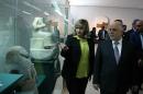 Iraq's Prime Minister Haider al-Abadi visits the Iraqi National Museum in Baghdad, Iraq, Saturday, Feb. 28, 2015. Al-Abadi vowed to track down and punish those who were behind the smashing of rare ancient artifacts in the northern Iraqi city of Mosul. On Thursday, the Islamic State group released a video purportedly showing militants using sledgehammers to smash the statues, describing them as idols that must be removed. The act brought global condemnation. (AP Photo)