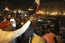 Supporters of Sisi greet police officers while they celebrate at Tahrir square in Cairo