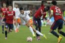 Montpellier's Morgan Sanson, center, controls the ball during their French League one soccer match against LiLle at the Lille Metropole stadium, in Villeneuve d'Ascq, northern France, Sunday, Sept. 21, 2014. (AP Photo/Michel Spingler)