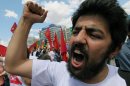 A Turkish protester shouts slogans such as "don't yield " as thousands of trade union members who are on a two-day strike march to Kizilay Square, Ankara, Turkey, Wednesday, June 5, 2013. In Ankara and Istanbul some demonstrations were largely jovial and humorous, calling themselves "looters," asked Turkey's prime minister Recep Tayyip Erdogan to resign. (AP Photo/Burhan Ozbilici)