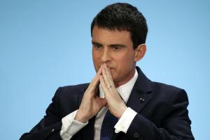 French Prime Minister Manuel Valls listens as he unveils …
