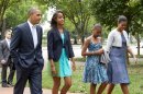 President Barack Obama, left, with first lady Michelle Obama, right, and their daughters Sasha and Malia, second from left, walk from the White House in Washington to a nearby church to attend services Sunday, Aug. 19, 2012. (AP Photo/Manuel Balce Ceneta)