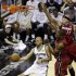 San Antonio Spurs point guard Tony Parker (9) passes the ball around Miami Heat forward Chris Andersen and center Chris Bosh (1) during the first half at Game 3 of the NBA Finals basketball series, Tuesday, June 11, 2013, in San Antonio. (AP Photo/David J. Phillip)