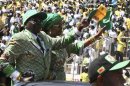 Zimbabwe's President Robert Mugabe and his wife Grace arrive to address the final rally of his ZANU (PF) party in Harare