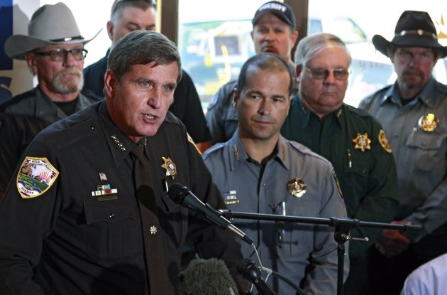 Weld County, Colo., Sheriff John Cooke, left, with El Paso County Sheriff Terry Maketa, center right, and other sheriffs standing behind him, speaks during a news conference at which he announced that 54 Colorado sheriffs are filing a federal civil lawsuit against two gun control bills passed by the Colorado Legislature, in Denver, Friday, May 17 2013. Among other claims, the group of sheriffs and others joining the suit argue that the laws violate the 2nd and 14th Amendments of the U.S. Constitution. (AP Photo/Brennan Linsley)