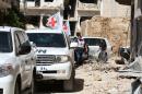 Vehicles of the International Committee of the Red Cross (ICRC) and the United Nations wait on a street after an aid convoy entered the rebel-held Syrian town of Daraya, southwest of the capital Damascus, on June 1, 2016