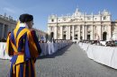 A Vatican Swiss guard stands in front of St. Peter's Basilica at the Vatican, Wednesday, Feb. 27, 2013. Pope Benedict XVI is preparing for his final general audience, the weekly appointment he kept with the faithful and tourists to teach them about the Catholic faith. (AP Photo/Michael Sohn)