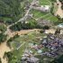 A road, left, is buried in a landslide in Yame, Fukuoka Prefecture, Japan, Sunday, July 15, 2012. Heavy rain triggered flash floods and mudslides in southern Japan this week, killing over two dozens of people. (AP Photo/Kyodo News) JAPAN OUT, MANDATORY CREDIT, NO LICENSING IN JAPAN, CHINA, HONG KONG, SOUTH KOREA AND FRANCE