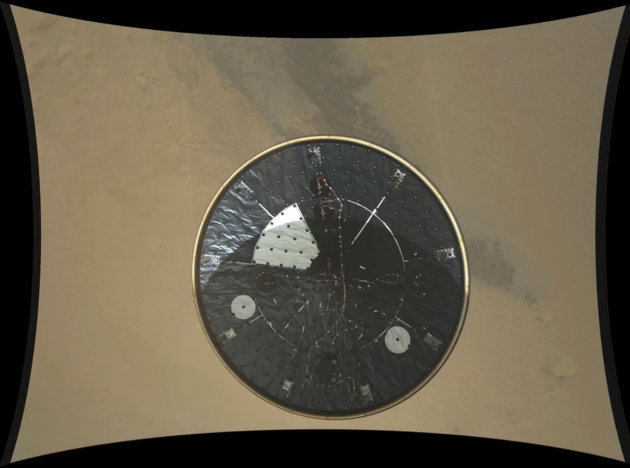In this frame of a high definition stop motion video taken during the NASA rover Mars landing and provided by the space agency on Thursday, Aug. 23, 2012, the heat shield falls away during Curiosity's descent to the surface of Mars on Sunday, Aug. 5, 2012. Curiosity is the first spacecraft to record a landing on another planet. The six-wheel rover arrived on Aug. 5 to begin a two-year mission to examine whether the Martian environment was hospitable for microbial life. (AP Photo/NASA/JPL-Caltech/MSSS)