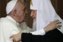 Pope Francis, left, embraces Russian Orthodox Patriarch Kirill after signing a joint declaration on religious unity at the Jose Marti International airport in Havana, Cuba, Friday, Feb. 12, 2016. The two religious leaders met for the first-ever papal meeting, a historic development in the 1,000-year schism within Christianity. (AP Photo/Gregorio Borgia, Pool)