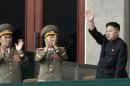 FILE - In this April 14, 2012 file photo, North Korean leader Kim Jong Un, right, waves as North Korean military officers clap during a mass meeting of North Korea's ruling party at a stadium in Pyongyang, North Korea. North Korean state media made the announcement Wednesday, July 18, 2012 in a special bulletin that Kim has been promoted to marshal, the military's highest rank. (AP Photo/Ng Han Guan, File)