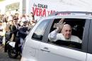 Pope Francis waves as he arrives to visit the Banado Norte neighborhood in Asuncion
