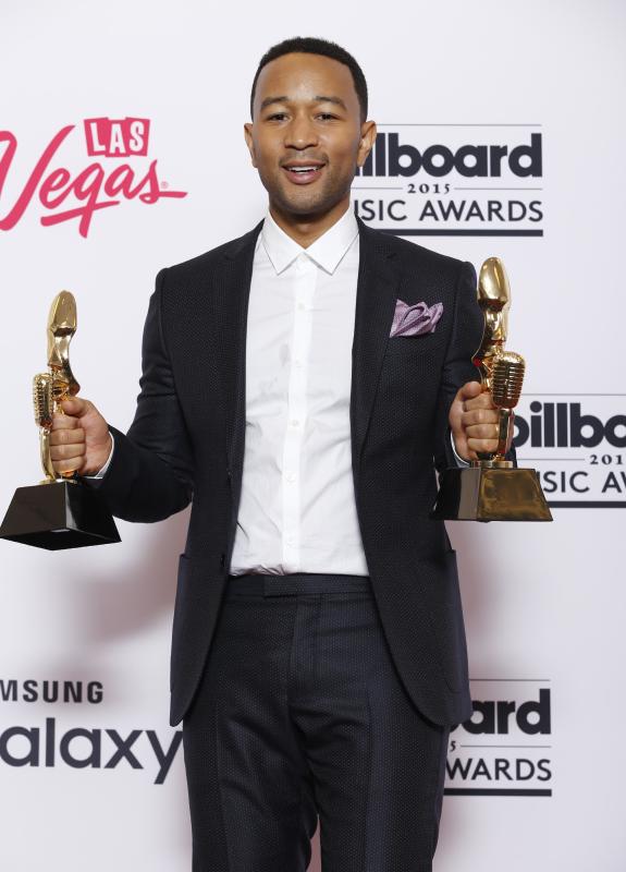 John Legend poses in the press room with the awards for top radio song for “All of Me” and top streaming song for “All of Me” at the Billboard Music Awards at the MGM Grand Garden Arena on Sunday, May 17, 2015, in Las Vegas. (Photo by Eric Jamison/Invision/AP)