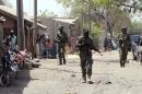This file picture taken on April 30, 2013 shows Nigerian troops patrolling in the streets of the remote northeast town of Baga