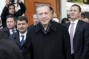 Erdogan smiles as he leaves from Eyup Sultan mosque in Istanbul