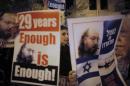 Israelis hold placards depicting Pollard during a protest calling for his release from a U.S. prison, outside U.S. Secretary of State Kerry's hotel in Jerusalem