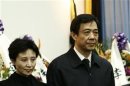 China's former Chongqing Municipality Communist Party Secretary Bo and his wife stand at a mourning held for his father in Beijing